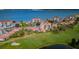 Scenic aerial view of condos, lush golf course, and serene waterfront, blending luxury and natural beauty at 6180 Sun Blvd # 204, St Petersburg, FL 33715