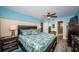 Well-lit bedroom boasts a queen bed, wood-style floors, and an ensuite bathroom and closet at 6180 Sun Blvd # 204, St Petersburg, FL 33715