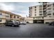 Condo building exterior with parking garage and landscaping at 6180 Sun Blvd # 204, St Petersburg, FL 33715