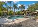 Large kidney shaped pool with surrounding patio and tropical landscaping at 6256 28Th N Ter, St Petersburg, FL 33710