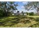 Large grassy backyard with mature trees and privacy at 6522 Spyglass Ln, Bradenton, FL 34202