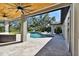 Covered patio with pool and backyard views; ceiling fans at 6522 Spyglass Ln, Bradenton, FL 34202