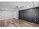 Large bedroom with dark gray accent wall and wood-look floors at 7330 Live Oak Ln, New Port Richey, FL 34653