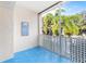 Screened balcony overlooking lush tropical landscape at 820 Patricia Ave # 207, Dunedin, FL 34698