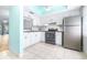 Modern kitchen with stainless steel appliances and white cabinetry, ample counter space at 820 Patricia Ave # 207, Dunedin, FL 34698