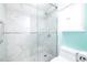 Large walk-in shower with marble tile and glass enclosure at 820 Patricia Ave # 207, Dunedin, FL 34698