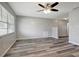 Bright living room with gray walls, wood-look flooring, and a ceiling fan at 8411 7Th N St, St Petersburg, FL 33702