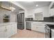 Stylish kitchen featuring white shaker cabinets, stainless steel appliances, and a farmhouse sink at 851 16Th S Ave, St Petersburg, FL 33701