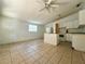 Simple kitchen with white cabinets and tiled floor at 9405 N Mulberry St, Tampa, FL 33612