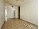 Living room with tiled floors and access to other rooms at 9405 N Mulberry St, Tampa, FL 33612