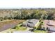 Aerial view of house on a lake in a wooded area at 10527 Machrihanish Cir, San Antonio, FL 33576