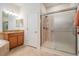 Bathroom with walk-in shower and granite vanity at 10527 Machrihanish Cir, San Antonio, FL 33576