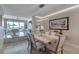 Open concept dining room with a marble table, six chairs, and a view into the living room and kitchen at 1069 Pinellas Bayway S, Tierra Verde, FL 33715