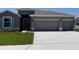 Charming single-story home with a manicured lawn and a three car garage at 10725 Tippecanoe Pl, Parrish, FL 34219