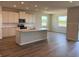 Bright, open kitchen featuring an island, modern appliances and white cabinets at 10725 Tippecanoe Pl, Parrish, FL 34219