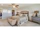 Main bedroom with king-size bed and stylish wood accent wall at 10805 Patoka Ter, Parrish, FL 34219