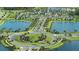 Community entrance and roundabout with landscaping and lake views at 11211 Livewell Ct, Venice, FL 34293