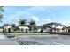 Community building with parking area and landscaping at 11211 Livewell Ct, Venice, FL 34293
