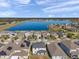 Aerial view of a lakefront community with numerous houses and solar panels at 11321 Chilly Water Ct, Riverview, FL 33569