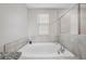 Relaxing bathroom with a large soaking tub and a window at 11321 Chilly Water Ct, Riverview, FL 33569