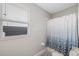 Clean bathroom with shower/tub combo and a window at 11321 Chilly Water Ct, Riverview, FL 33569