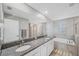 Elegant bathroom with double vanity, granite countertop, and soaking tub at 11321 Chilly Water Ct, Riverview, FL 33569