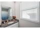 Well-lit bathroom with vanity, granite countertop, and window at 11321 Chilly Water Ct, Riverview, FL 33569