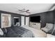 Spacious bedroom with large TV, comfortable seating, and ensuite bathroom access at 11321 Chilly Water Ct, Riverview, FL 33569