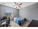 Bright bedroom with a window, ceiling fan, and workspace at 11321 Chilly Water Ct, Riverview, FL 33569