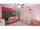 Adorable Bedroom with pink color scheme, crib, and decorative wall at 11321 Chilly Water Ct, Riverview, FL 33569