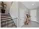 Staircase and entryway with console table and autumn decor at 11321 Chilly Water Ct, Riverview, FL 33569