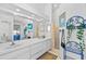Clean bathroom with dual sinks, large mirror, and shower at 1202 Sawdust Ct, Valrico, FL 33596