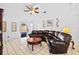 Spacious living room with a large sectional sofa and tiled floors at 1202 Sawdust Ct, Valrico, FL 33596