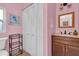 Pink bathroom with a vanity, toilet, and built-in storage at 1219 46Th N Ave, St Petersburg, FL 33703