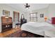 Bedroom with ceiling fan, hardwood floors, and antique desk at 1219 46Th N Ave, St Petersburg, FL 33703