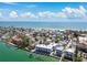 Stunning aerial view of beachfront homes and condos with dock access and the beautiful Gulf of Mexico in the background at 143 94Th Ave # 2, Treasure Island, FL 33706