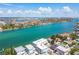 Expansive aerial view of the intercoastal waterway with beautiful residential buildings in the backdrop on a bright sunny day at 143 94Th Ave # 2, Treasure Island, FL 33706