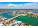 Panoramic aerial view of the intercoastal waterway with a bridge, marina, and vibrant residential buildings in the distance at 143 94Th Ave # 2, Treasure Island, FL 33706