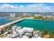 Scenic aerial view showcasing the intercoastal waterway, a bridge, a marina, and charming residential buildings and landscapes at 143 94Th Ave # 2, Treasure Island, FL 33706