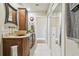 Inviting bathroom featuring dual vanities, wooden cabinetry, and mirrors with decorative frames at 143 94Th Ave # 2, Treasure Island, FL 33706