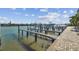 View of a private boat dock extending into tranquil waters, with boat lifts and ample space at 143 94Th Ave # 2, Treasure Island, FL 33706