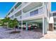 Multi-story waterfront building with tropical landscaping and covered parking at 143 94Th Ave # 2, Treasure Island, FL 33706