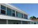 Two story condominium building featuring modern architecture, impact windows, and a metal roof at 143 94Th Ave # 2, Treasure Island, FL 33706