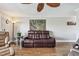 Living room with dark brown, reclining leather sofa and accent chair at 143 94Th Ave # 2, Treasure Island, FL 33706