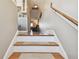 View of bright stairway leading to the next level of the home. Features wood railing and treads at 143 94Th Ave # 2, Treasure Island, FL 33706