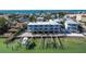 Aerial view of waterfront building, boat slips, and nearby homes at 143 94Th Ave # 2, Treasure Island, FL 33706