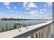 Waterfront balcony view with boat lift and peaceful waterscape at 143 94Th Ave # 2, Treasure Island, FL 33706