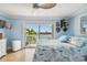 Bright bedroom with water views, ceiling fan, and comfortable bed at 143 94Th Ave # 2, Treasure Island, FL 33706