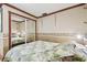 Small bedroom with a double bed and mirrored closet at 143 94Th Ave # 2, Treasure Island, FL 33706
