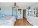 Bright bedroom with light blue walls, wood floors, and wicker dresser at 143 94Th Ave # 2, Treasure Island, FL 33706